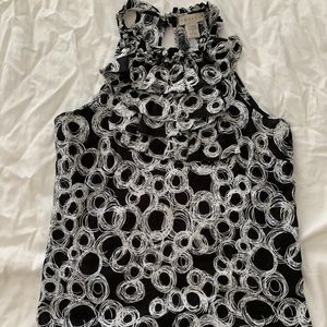 Sleeveless blouse with ruffles at the top